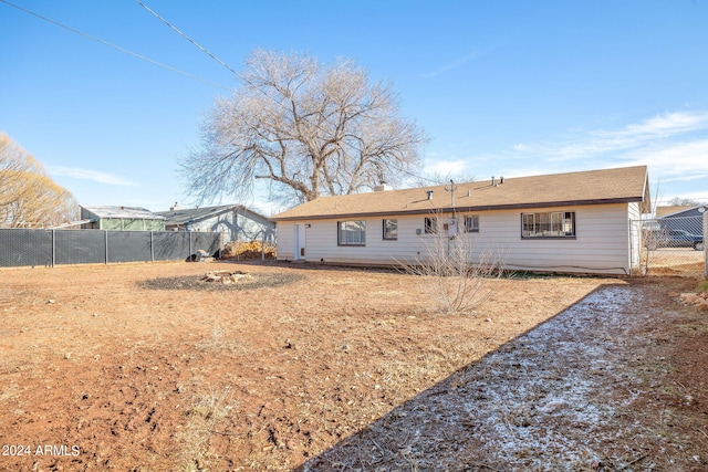 back of house with fence