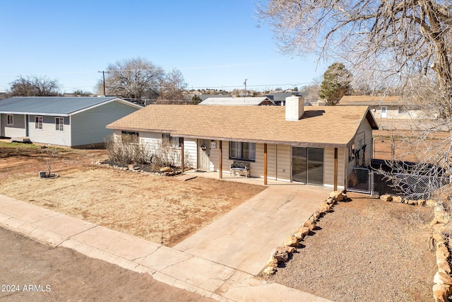 single story home with a shingled roof, fence, driveway, a gate, and a chimney