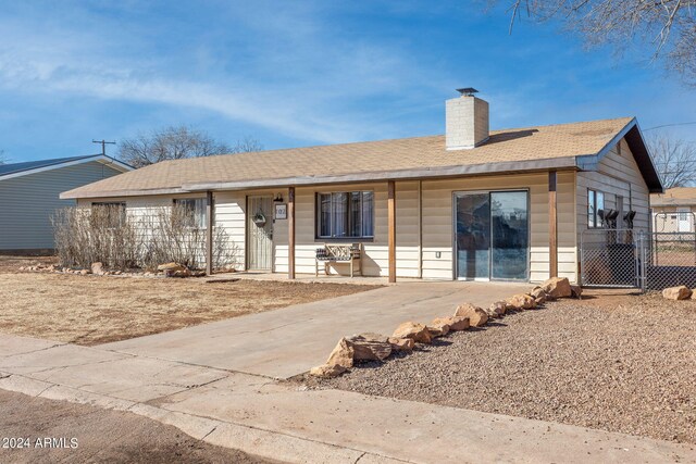 view of front of home featuring roof with shingles and a chimney