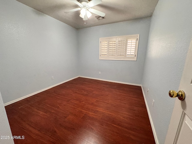 unfurnished room with ceiling fan and dark wood-type flooring