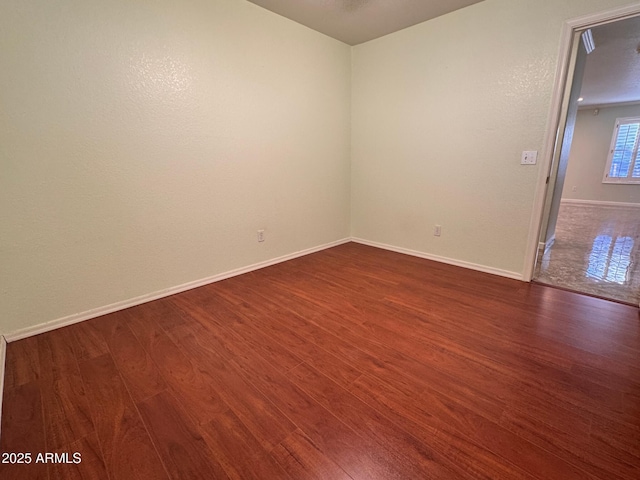 empty room with dark hardwood / wood-style floors