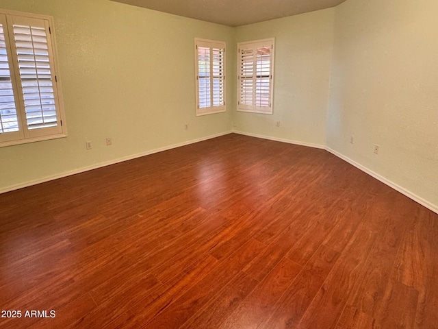 empty room with dark wood-type flooring