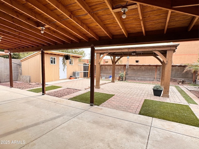 view of patio featuring central AC and a storage shed