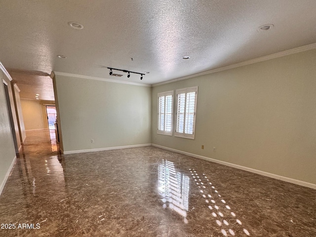 empty room with a textured ceiling, crown molding, and track lighting