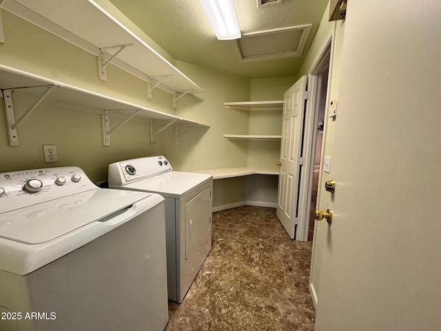 clothes washing area with washer and clothes dryer