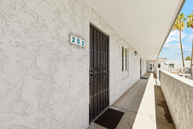 entrance to property with stucco siding