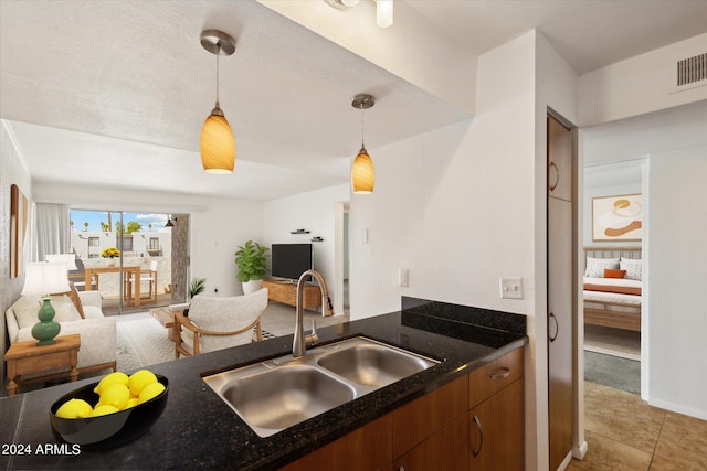 kitchen featuring decorative light fixtures, sink, and tile patterned floors