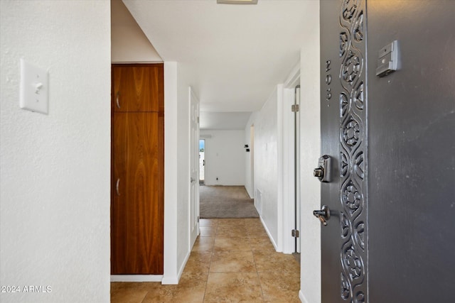 hallway with light tile patterned floors