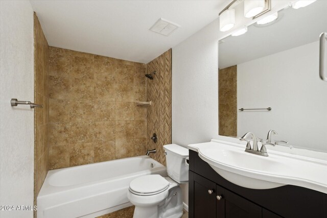 full bathroom with toilet, tiled shower / bath combo, and vanity