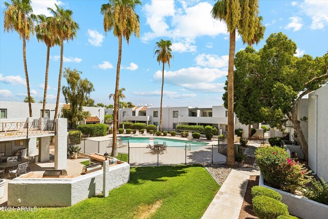 view of swimming pool with a yard and a patio