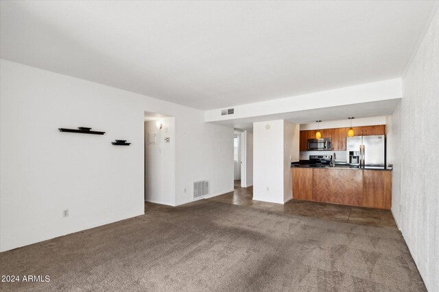 unfurnished living room featuring dark colored carpet