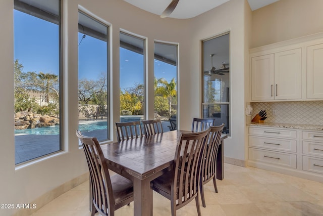 tiled dining room with ceiling fan