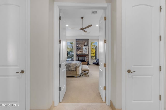 hallway with light carpet and crown molding