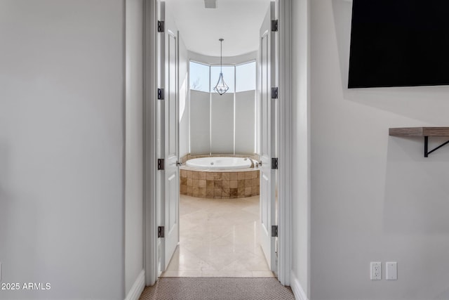 hall featuring light tile patterned flooring