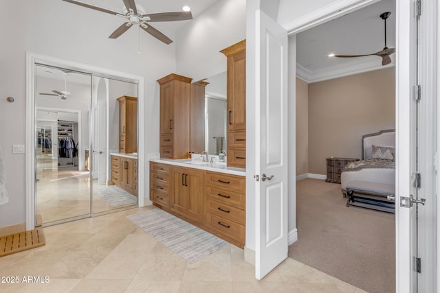 bathroom featuring vanity, crown molding, tile patterned floors, and ceiling fan