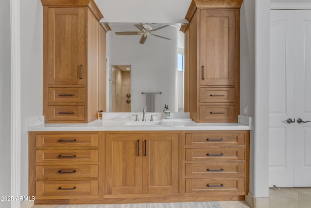 bathroom with vanity, ceiling fan, and walk in shower