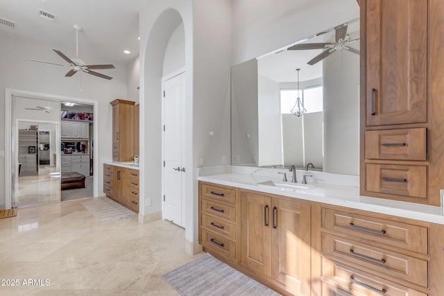 bathroom featuring ceiling fan and vanity