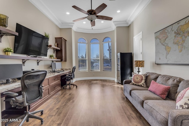 office area with ceiling fan, ornamental molding, dark hardwood / wood-style floors, and built in desk