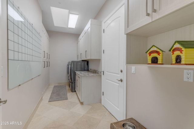 laundry room featuring cabinets and washing machine and clothes dryer