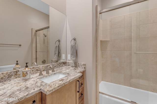 bathroom with vanity and combined bath / shower with glass door