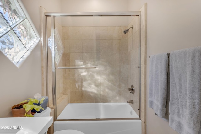 full bathroom featuring vanity, toilet, and combined bath / shower with glass door