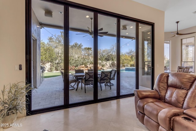 entryway with floor to ceiling windows, light tile patterned flooring, and ceiling fan