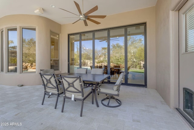 sunroom / solarium featuring ceiling fan