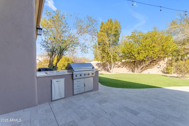 view of patio with an outdoor kitchen and area for grilling