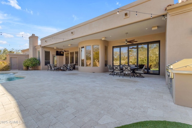 exterior space featuring ceiling fan