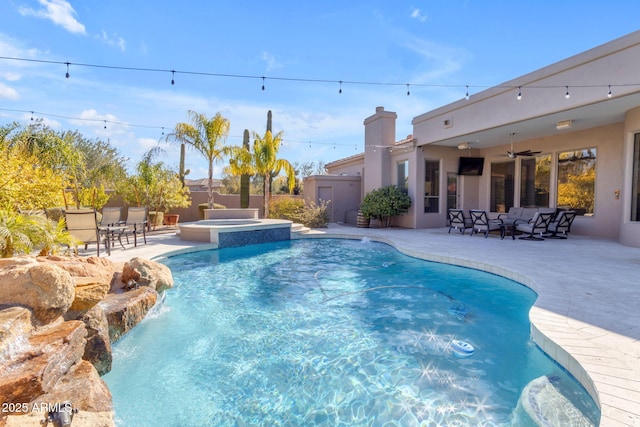 view of pool featuring a patio, outdoor lounge area, an in ground hot tub, pool water feature, and ceiling fan