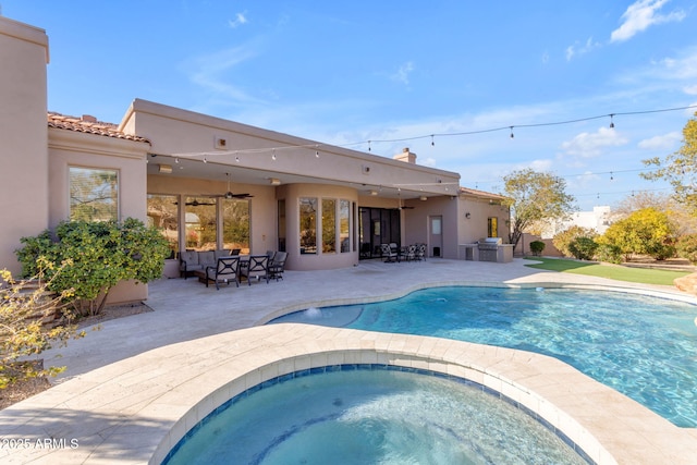 view of pool featuring a patio, ceiling fan, and an in ground hot tub