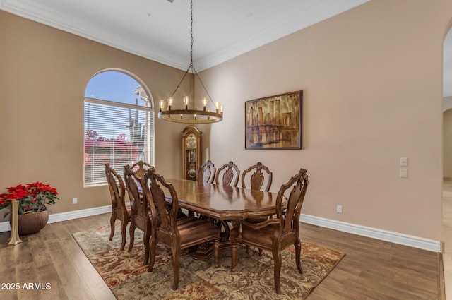 dining space featuring an inviting chandelier, crown molding, and dark wood-type flooring