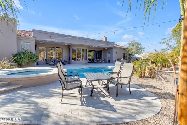 view of swimming pool with an in ground hot tub and a patio