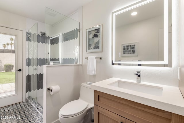 bathroom with toilet, walk in shower, and vanity