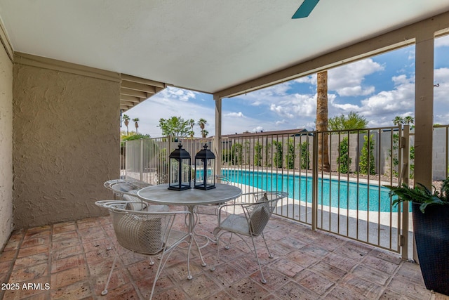view of swimming pool featuring fence and ceiling fan