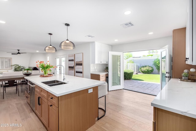 kitchen featuring a sink, light wood-style flooring, healthy amount of natural light, and recessed lighting
