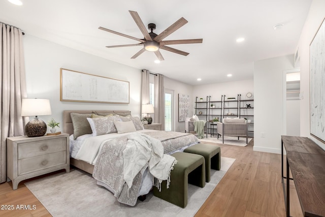 bedroom featuring light wood-type flooring, ceiling fan, recessed lighting, and a spacious closet