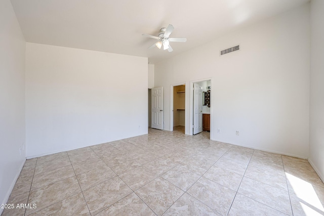 305 N Miller Rd, Buckeye, AZ 85326 - empty room with ceiling fan and light tile patterned floors