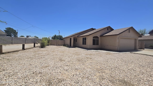 305 N Miller Rd, Buckeye, AZ 85326 - view of property exterior with an attached garage, stucco siding, driveway, and roof with shingles