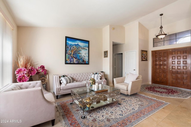 tiled living room featuring a healthy amount of sunlight and vaulted ceiling