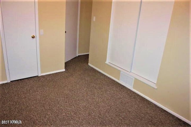 11201 W Missouri Ave, Youngtown, AZ 85363 - empty room with carpet floors, baseboards, and visible vents