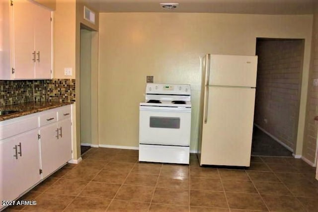 11201 W Missouri Ave, Youngtown, AZ 85363 - kitchen with visible vents, white appliances, tile patterned floors, white cabinets, and tasteful backsplash