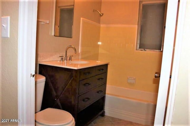11201 W Missouri Ave, Youngtown, AZ 85363 - full bathroom with vanity, washtub / shower combination, tile patterned floors, and toilet