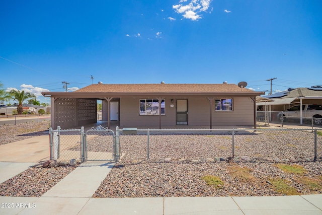 11201 W Missouri Ave, Youngtown, AZ 85363 - view of front facade with a fenced front yard, a porch, a gate, a carport, and driveway