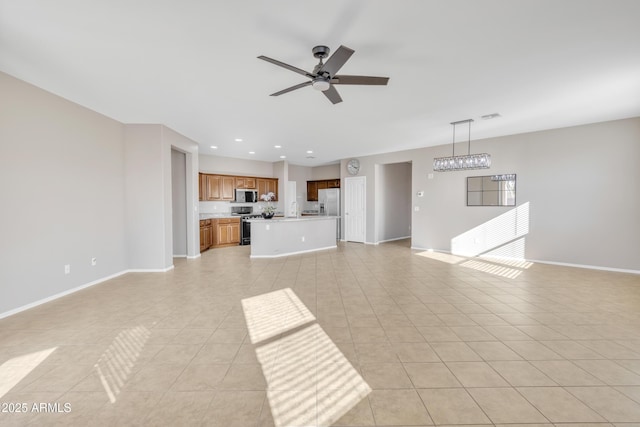 unfurnished living room featuring light tile patterned floors and ceiling fan