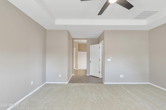 carpeted spare room with ceiling fan