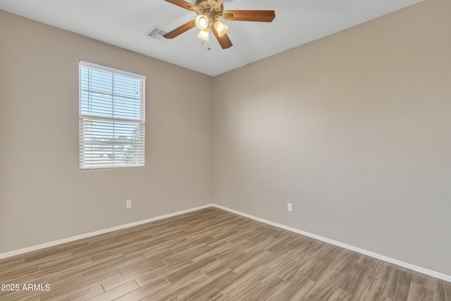 spare room with ceiling fan and light wood-type flooring