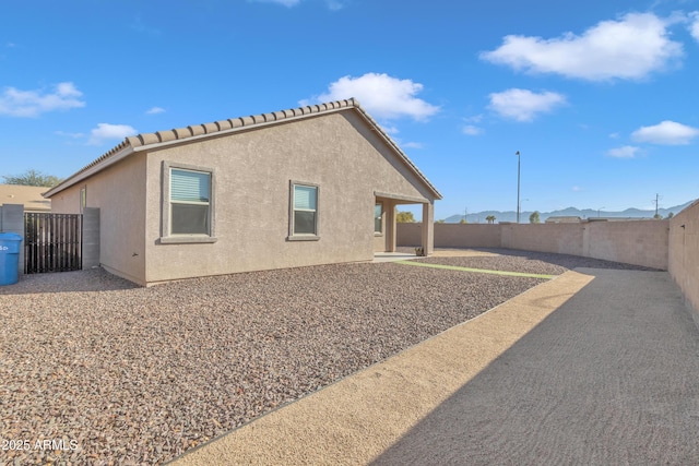 view of side of property with a patio