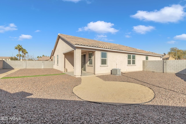 back of property with cooling unit and a patio