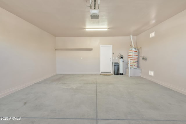 garage featuring a garage door opener and gas water heater